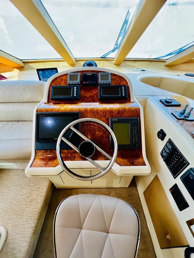 a table with a laptop and other objects on it aboard MAGIC MOMENTS Yacht for Sale