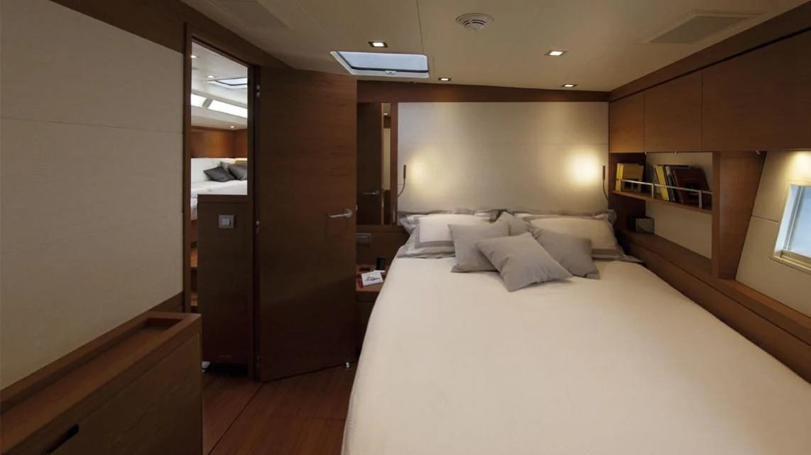 a room with a bed and a desk aboard GRILLO PARLANTE Yacht for Sale