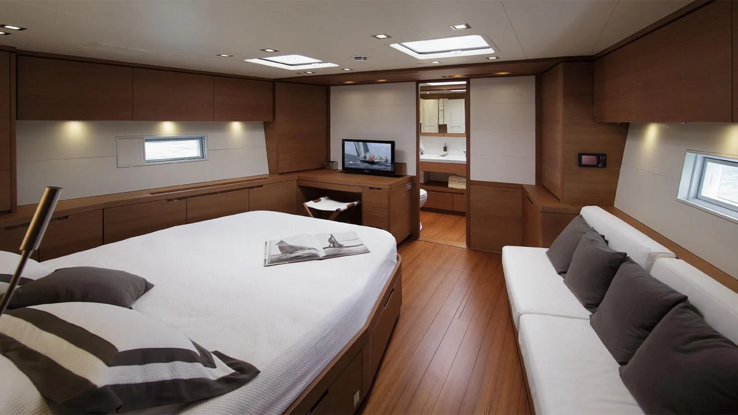 a room with a bed and a couch aboard GRILLO PARLANTE Yacht for Sale