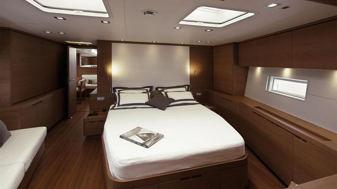 a room with a bed and a large screen aboard GRILLO PARLANTE Yacht for Sale