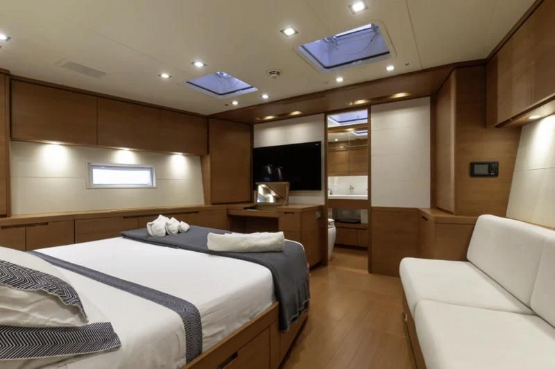 a room with a bed and a couch aboard GRILLO PARLANTE Yacht for Sale