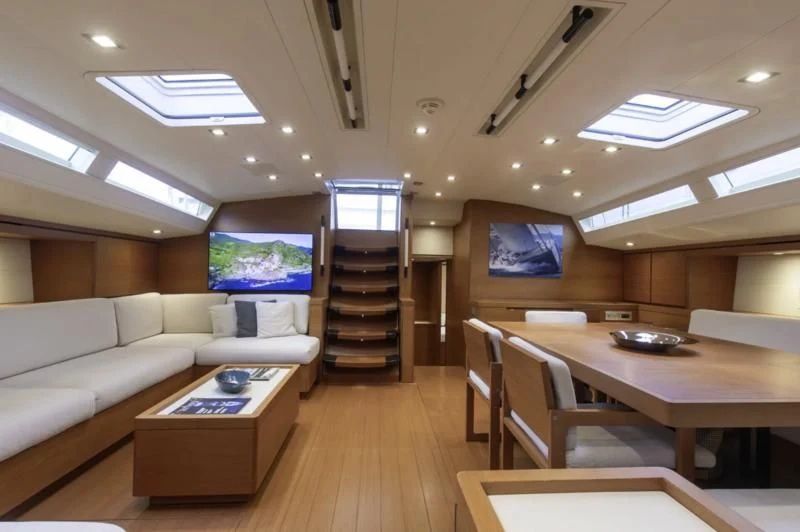 a living room with a couch and a table aboard GRILLO PARLANTE Yacht for Sale