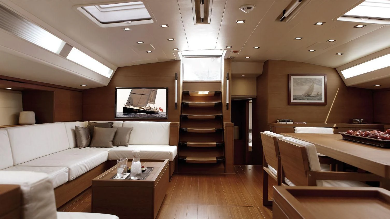 a room with a couch and a table aboard GRILLO PARLANTE Yacht for Sale