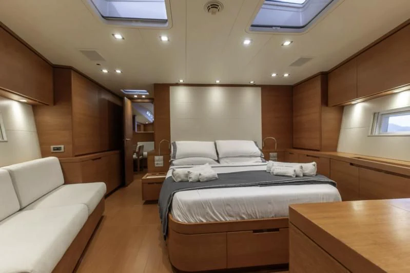a room with a bed and a desk aboard GRILLO PARLANTE Yacht for Sale
