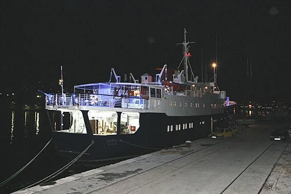 a large ship docked at night aboard EVANGELIYA Yacht for Sale