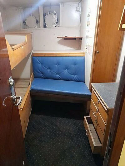 a blue couch in a room aboard EVANGELIYA Yacht for Sale