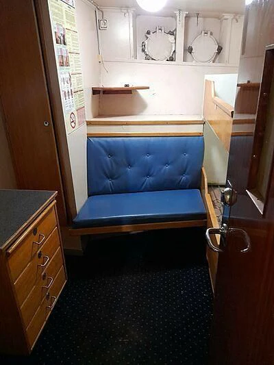 a blue couch in a room aboard EVANGELIYA Yacht for Sale
