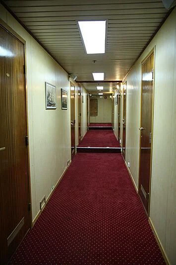 a hallway with a red carpet aboard EVANGELIYA Yacht for Sale