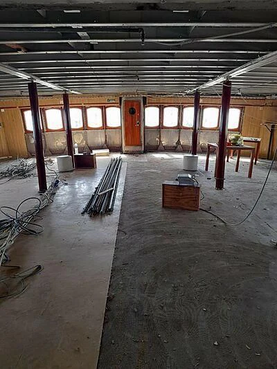 a room with a bench and a chair aboard EVANGELIYA Yacht for Sale