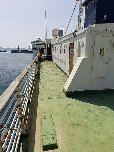 a white building next to a body of water aboard EVANGELIYA Yacht for Sale