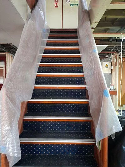 a set of stairs with a person standing on one side aboard EVANGELIYA Yacht for Sale