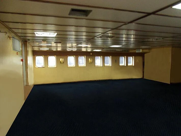 a room with a blue carpet aboard EVANGELIYA Yacht for Sale