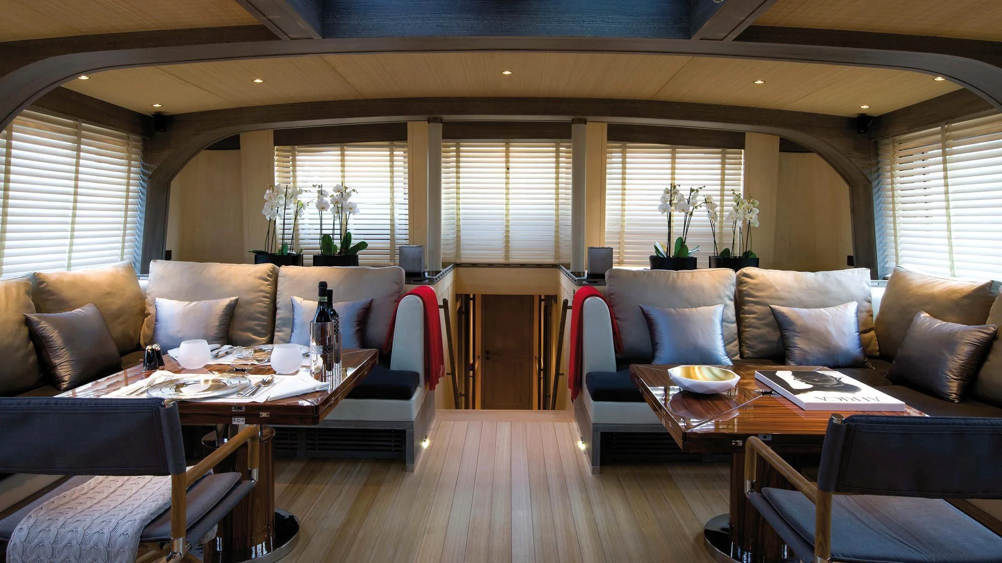 a living room with a table and chairs aboard ROXANE Yacht for Sale