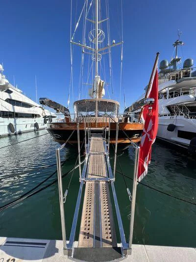 a boat with a flag on it aboard ROXANE Yacht for Sale