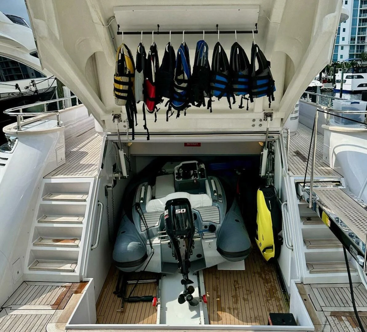 a white tent with a group of blue shoes from the ceiling aboard SEA METRI V Yacht for Sale