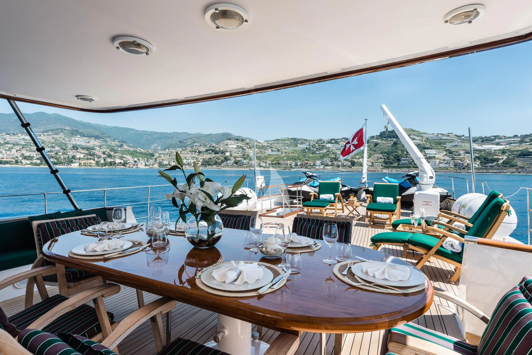 a table with plates and glasses on it aboard SOUTH PAW C Yacht for Sale