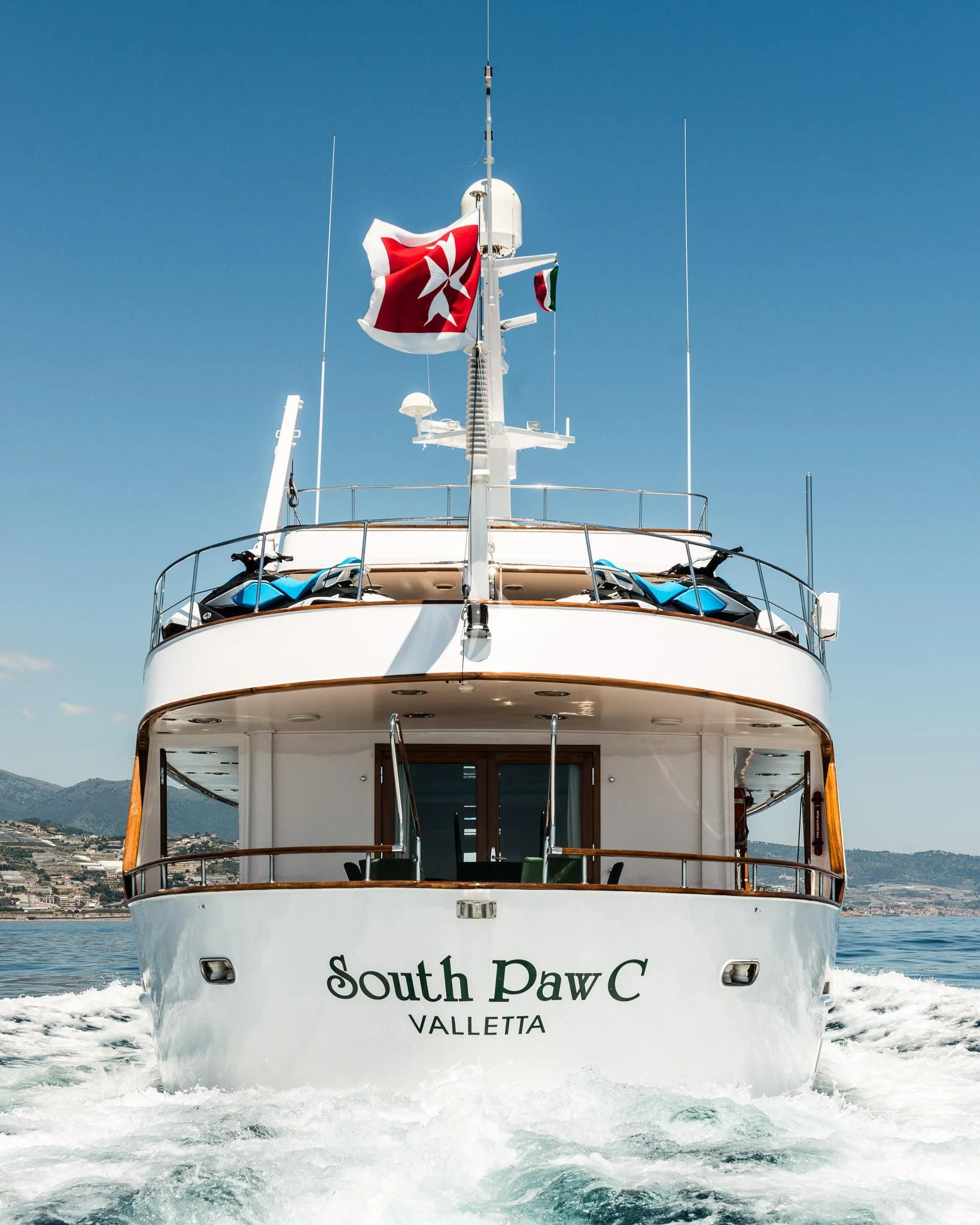 a boat with a flag on it aboard SOUTH PAW C Yacht for Sale