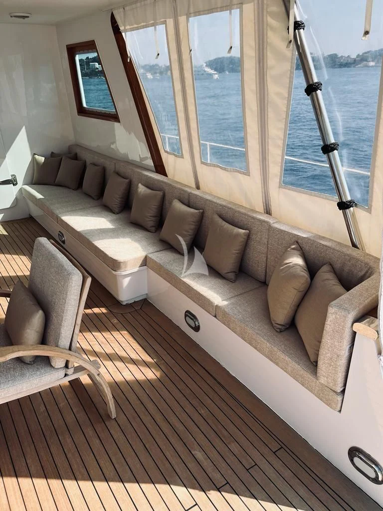 a couch with a window aboard SOUTH PAW C Yacht for Sale