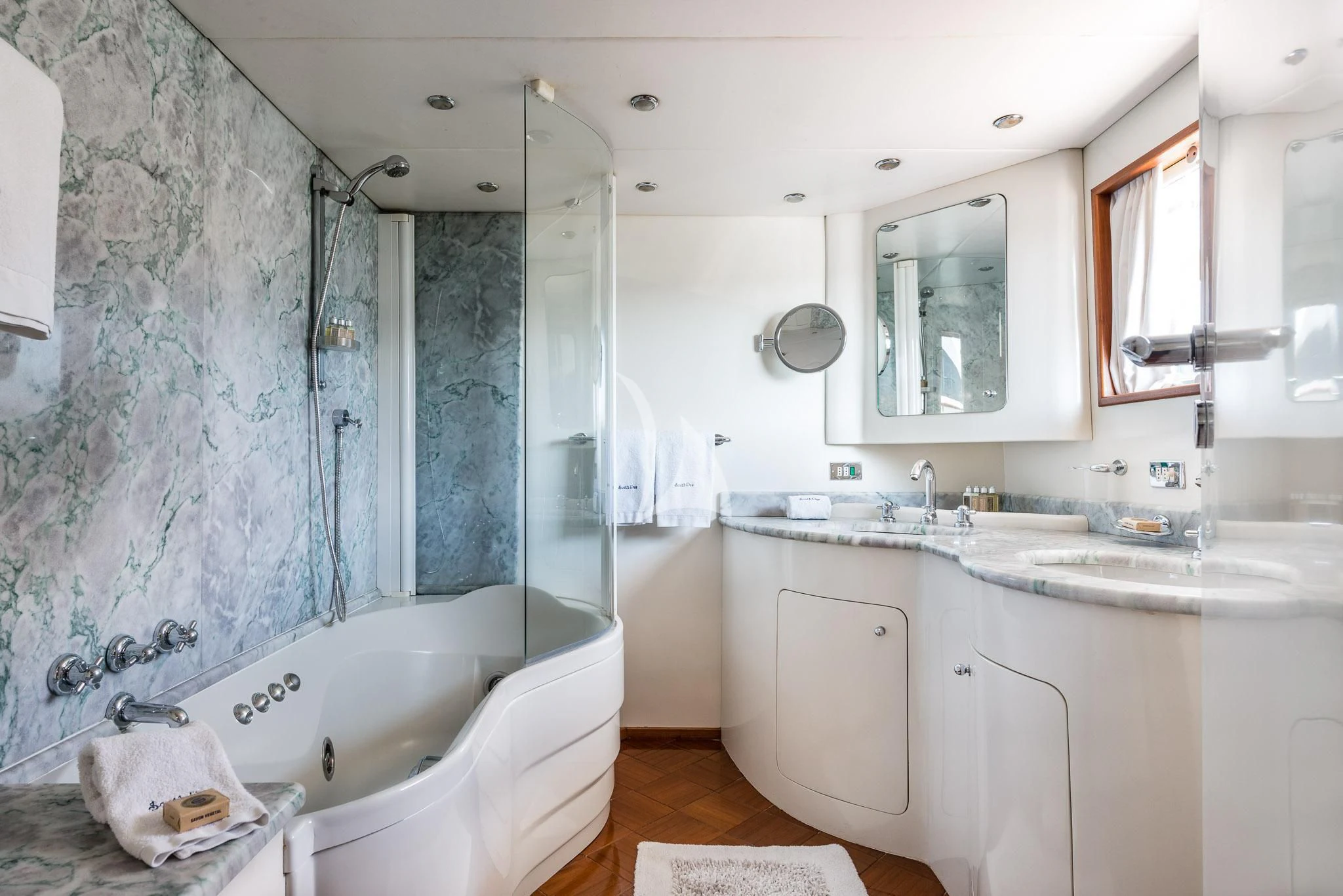 a bathroom with a tub sink and shower aboard SOUTH PAW C Yacht for Sale