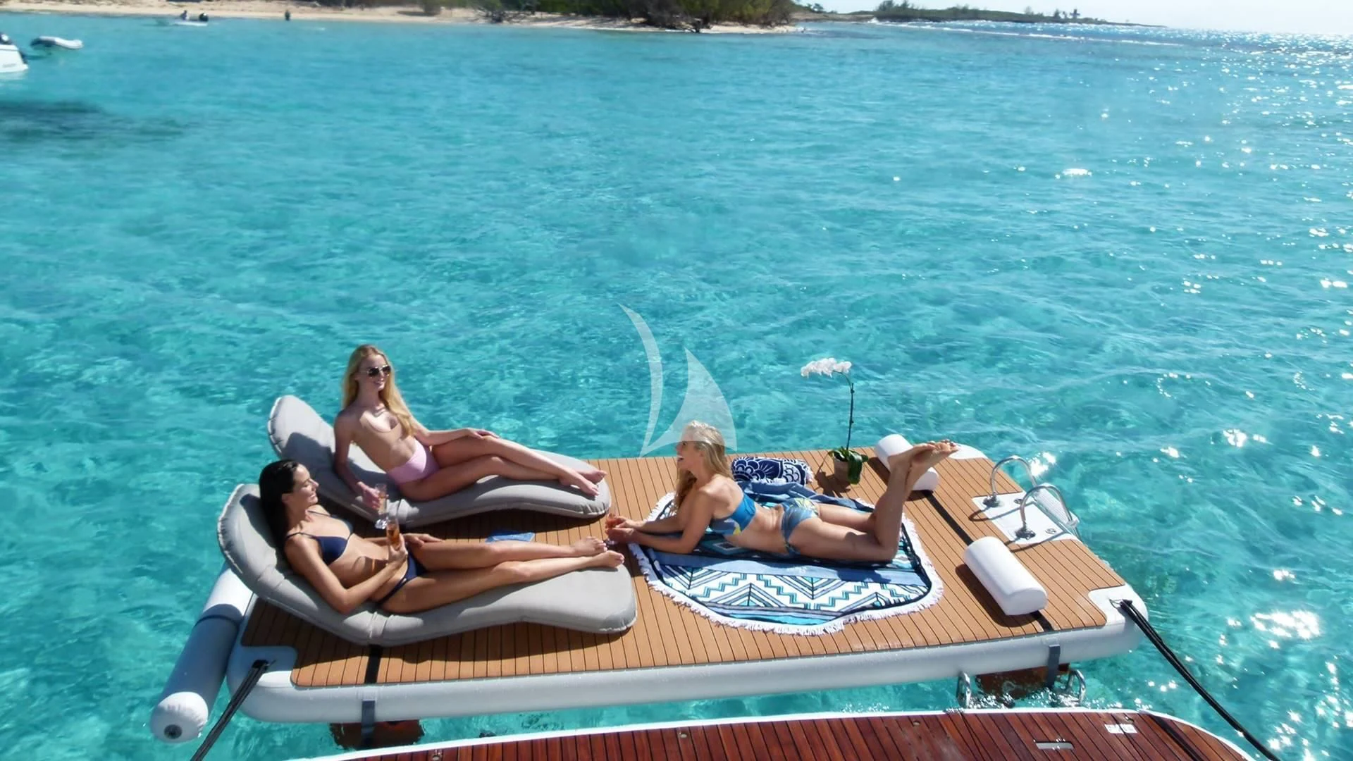 a group of people lounging on a lounge chair on a boat aboard SOUTH PAW C Yacht for Sale