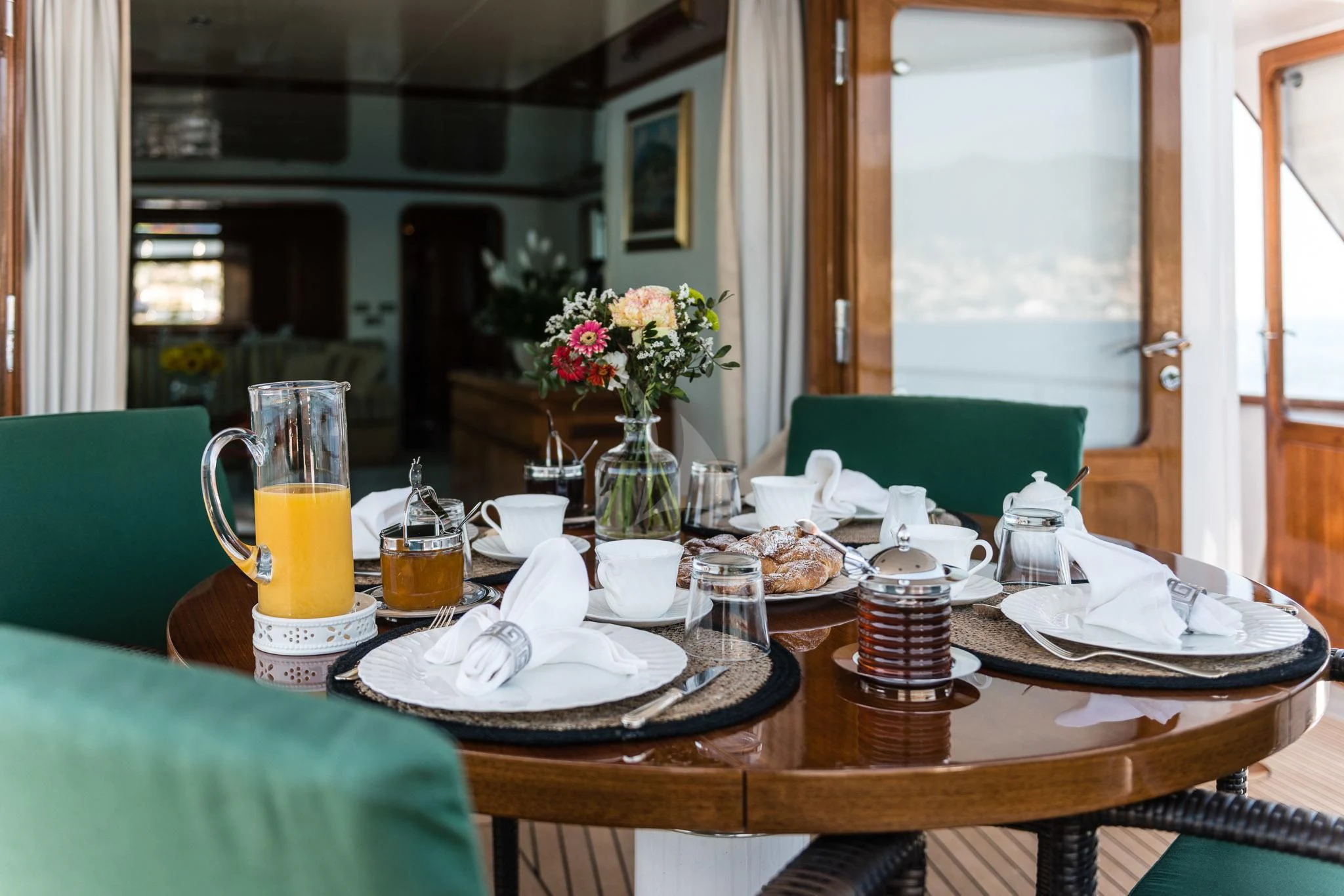 a table with food and drinks on it aboard SOUTH PAW C Yacht for Sale