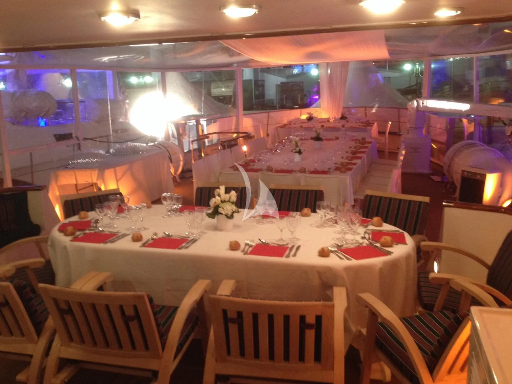 a room with tables and chairs aboard SOUTH PAW C Yacht for Sale