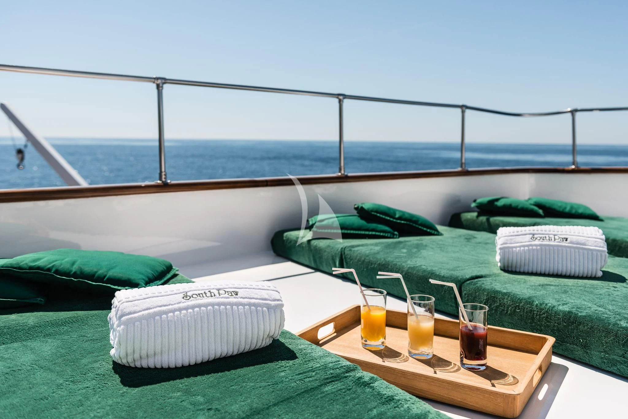 a bed with pillows and glasses on it aboard SOUTH PAW C Yacht for Sale