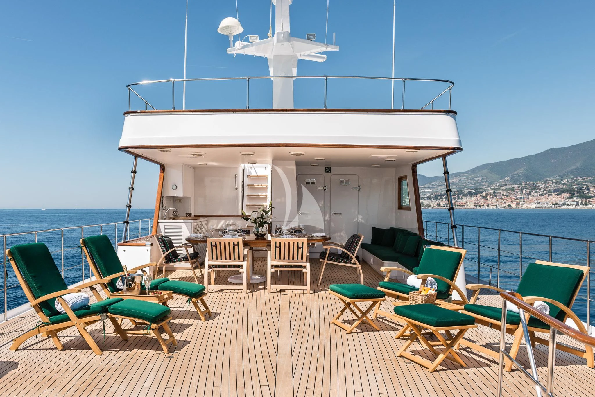 a building with a white roof and green chairs on a deck with a white fan on top of aboard SOUTH PAW C Yacht for Sale