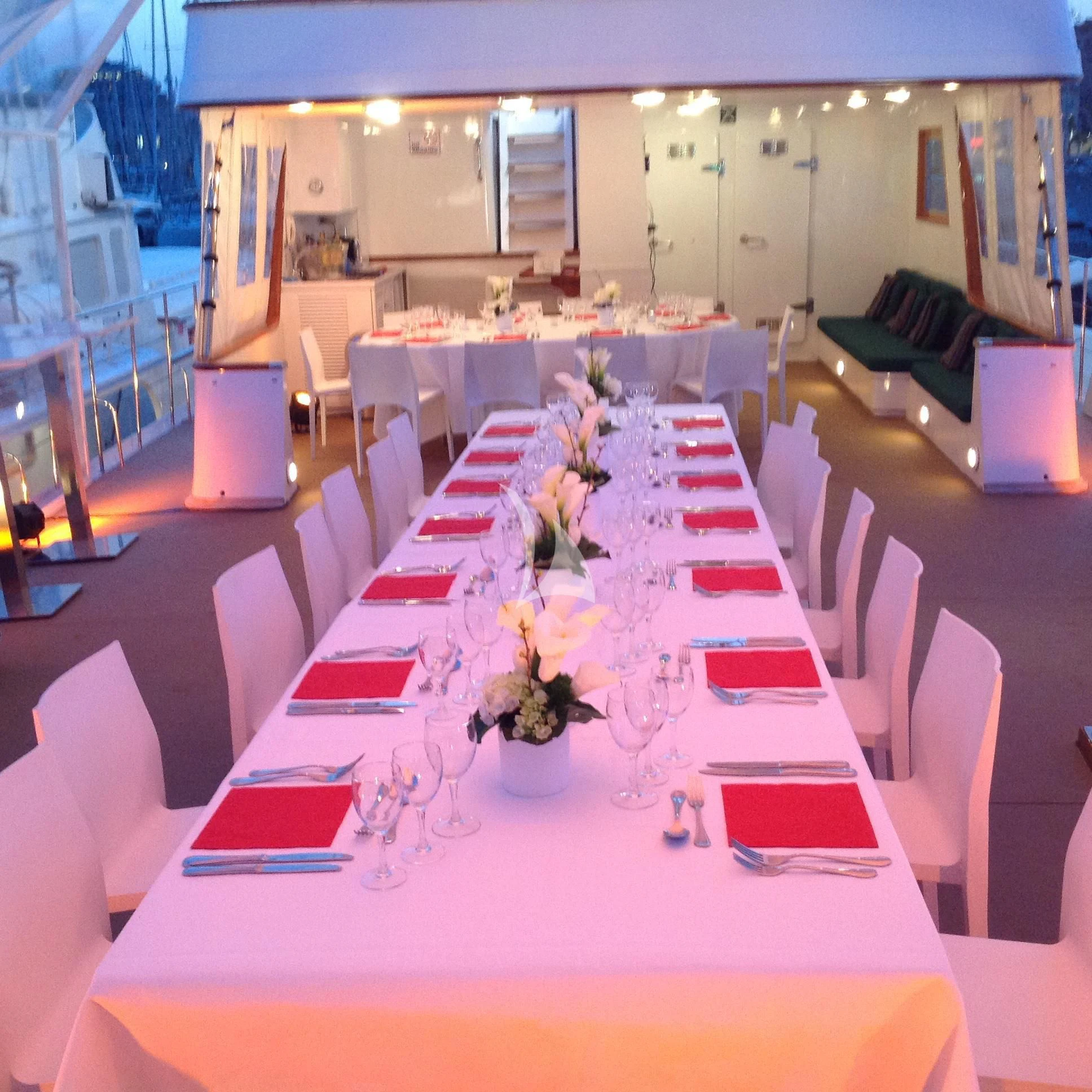 a room with tables and chairs aboard SOUTH PAW C Yacht for Sale