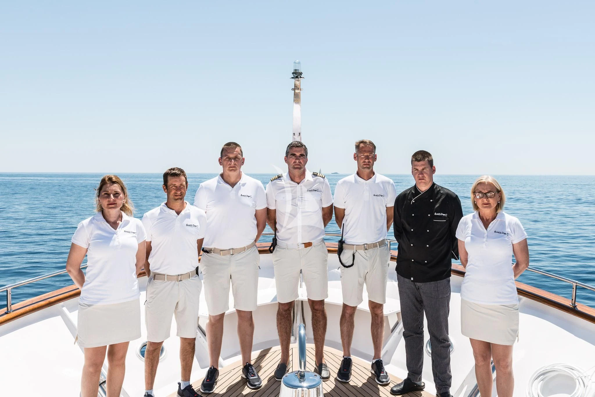 a group of people posing for a photo on a boat aboard SOUTH PAW C Yacht for Sale