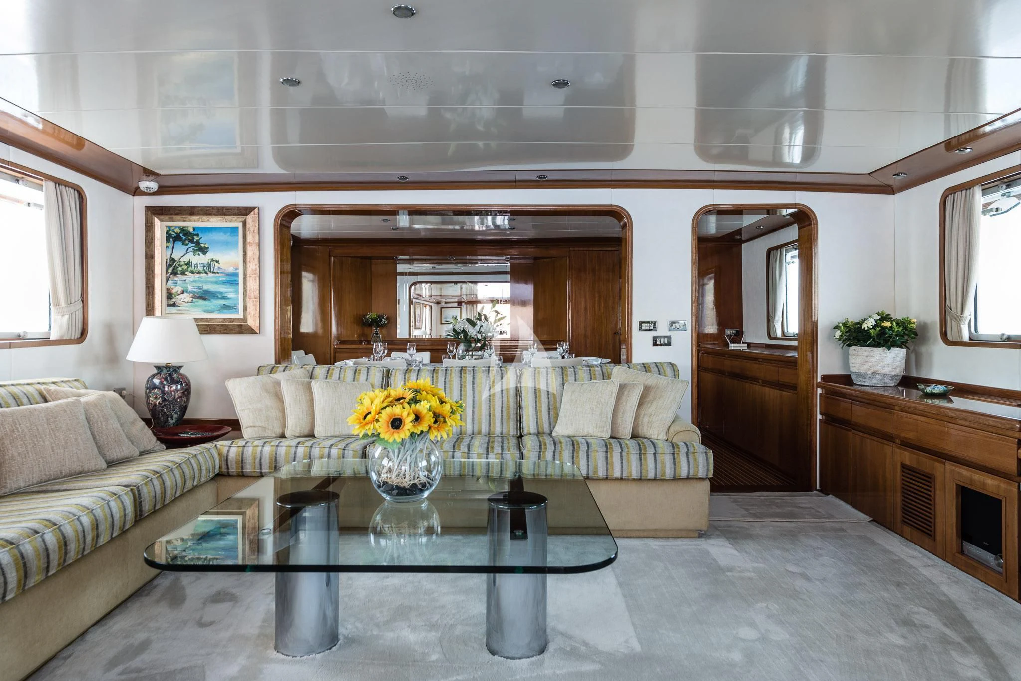 a living room with a white couch and a table aboard SOUTH PAW C Yacht for Sale