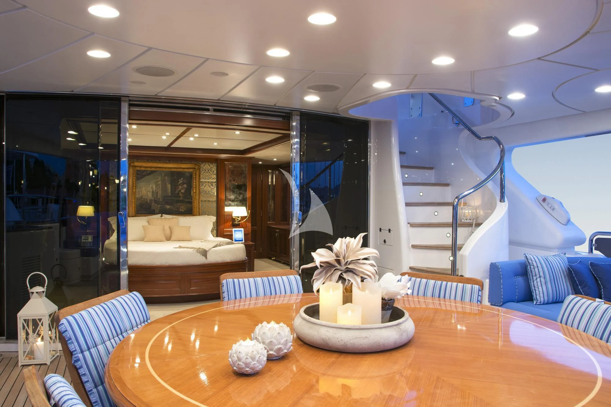 a large room with a table and chairs and a large window aboard OPTION B Yacht for Charter