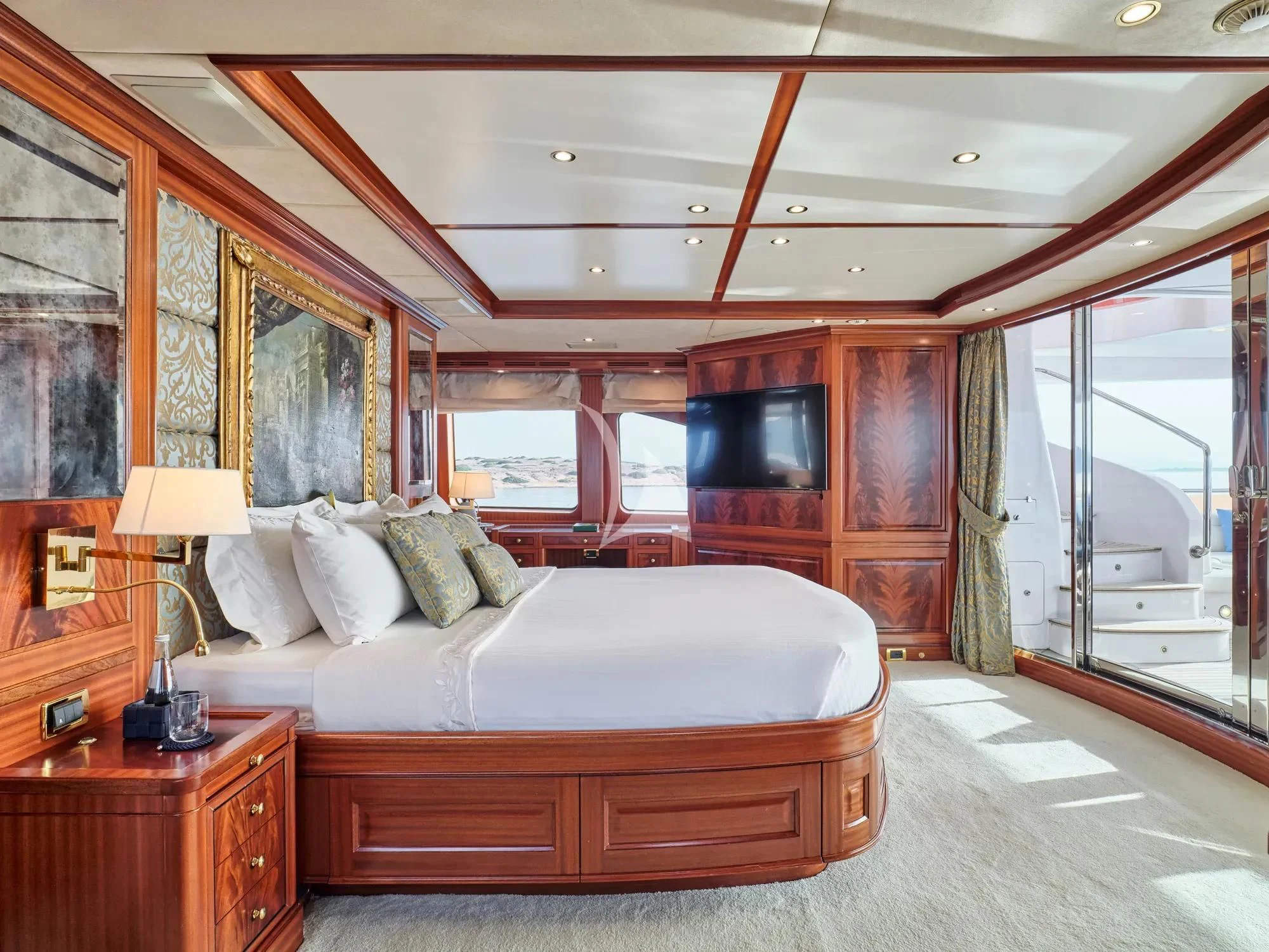 a bedroom with a bed and a desk aboard OPTION B Yacht for Charter
