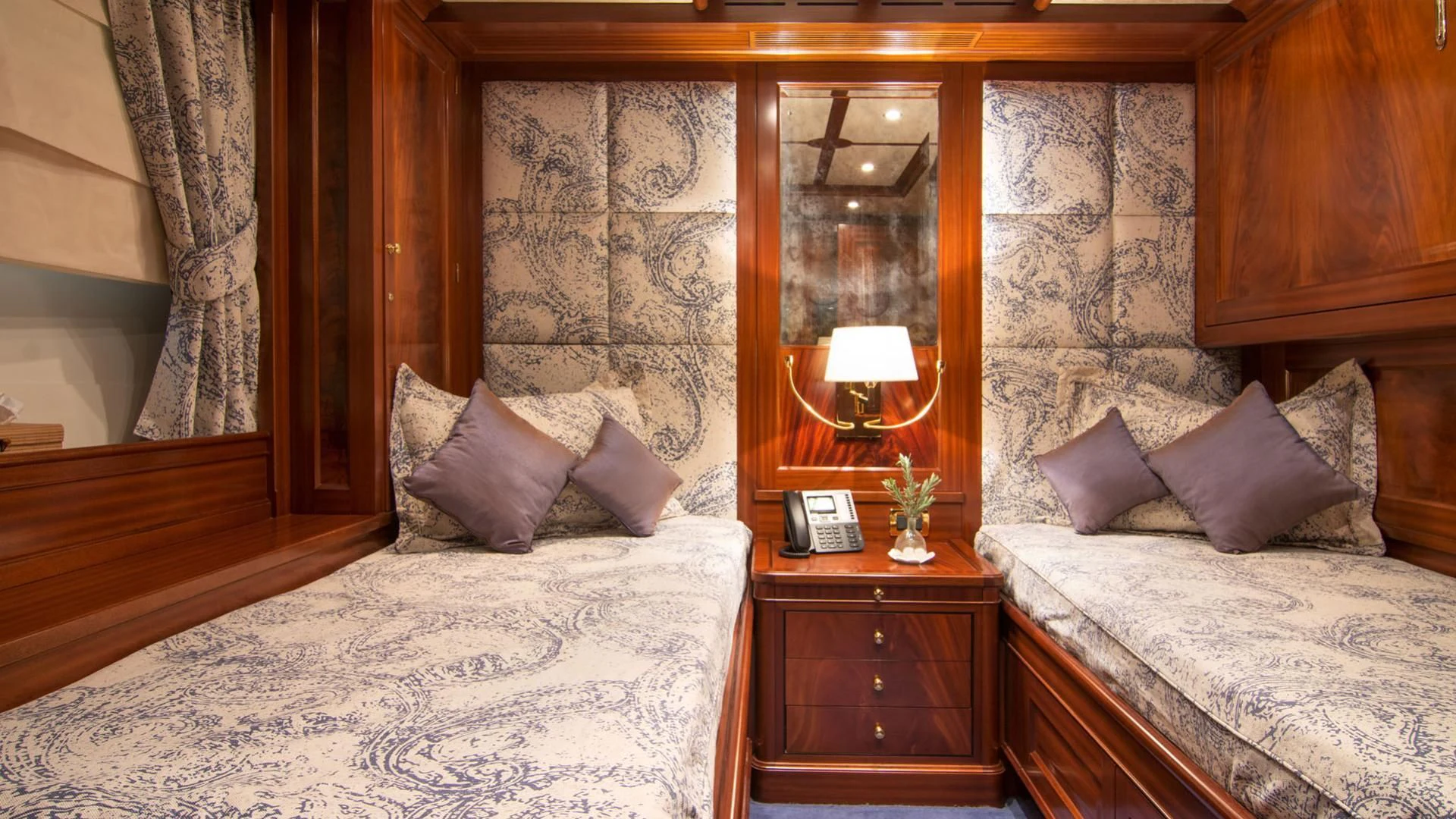 a room with a bed and a mirror aboard OPTION B Yacht for Charter
