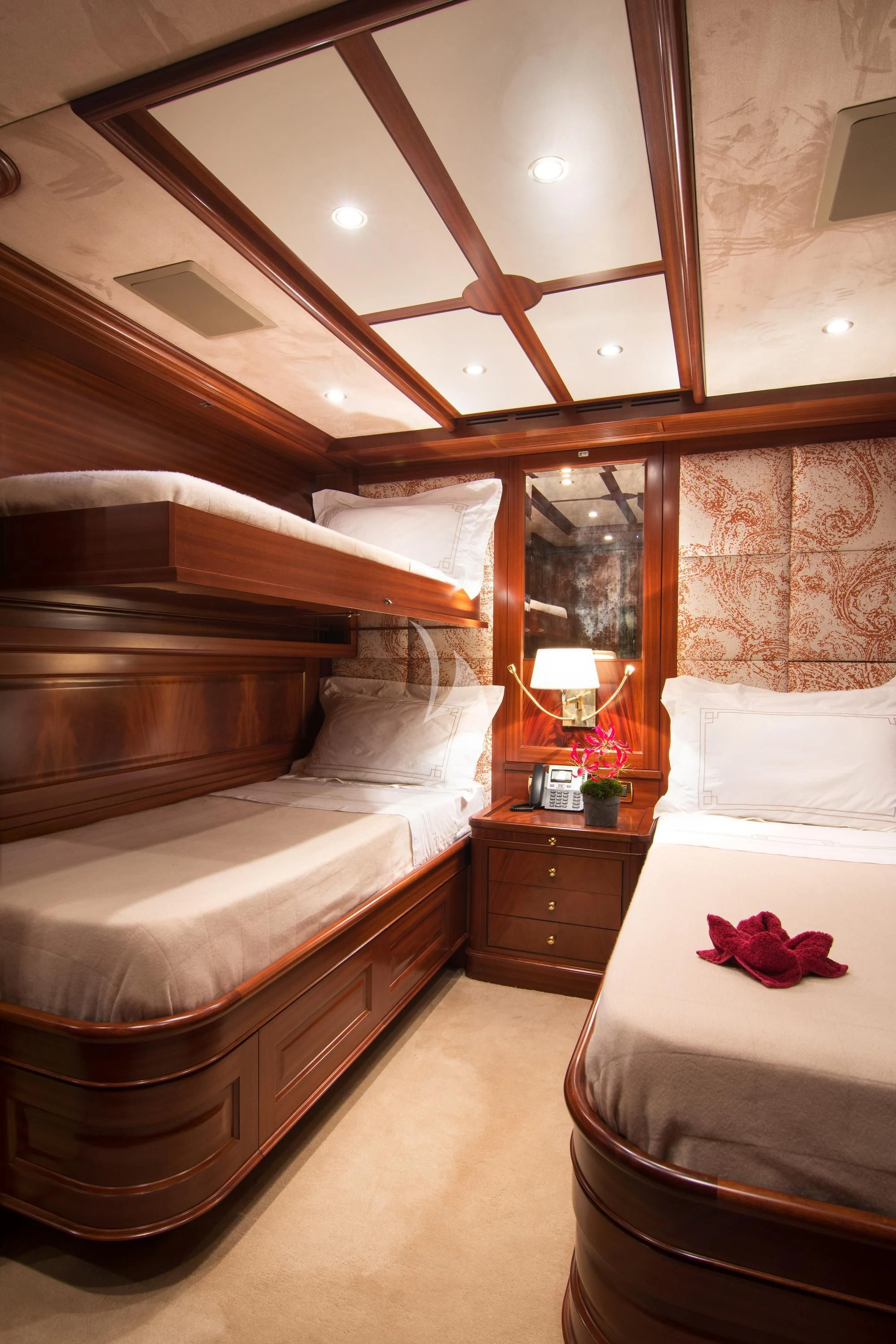 a room with a bed and a mirror aboard OPTION B Yacht for Charter