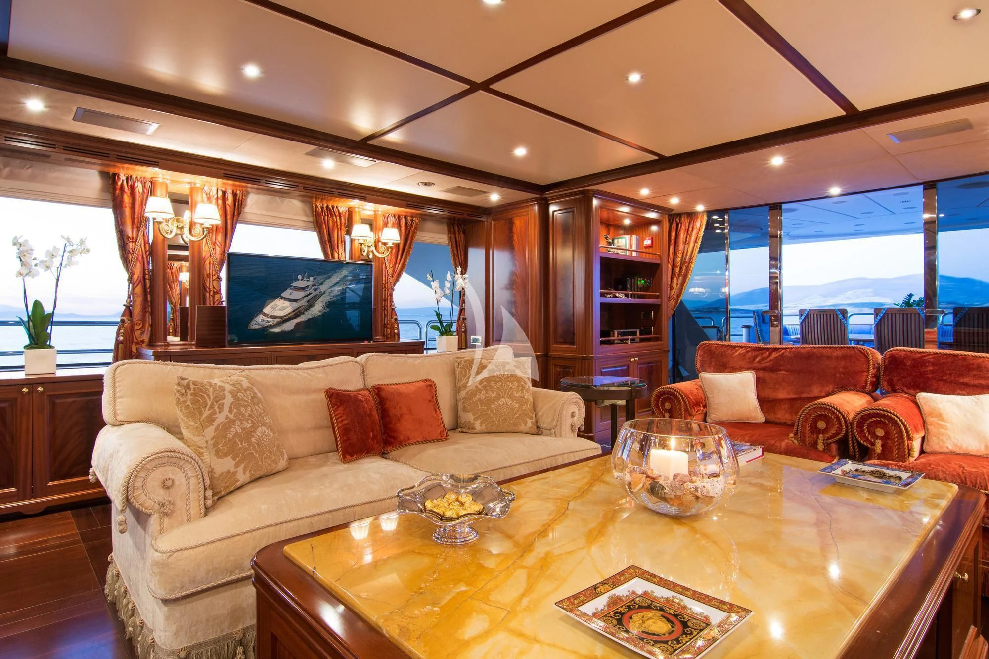 a living room with a large screen aboard OPTION B Yacht for Charter