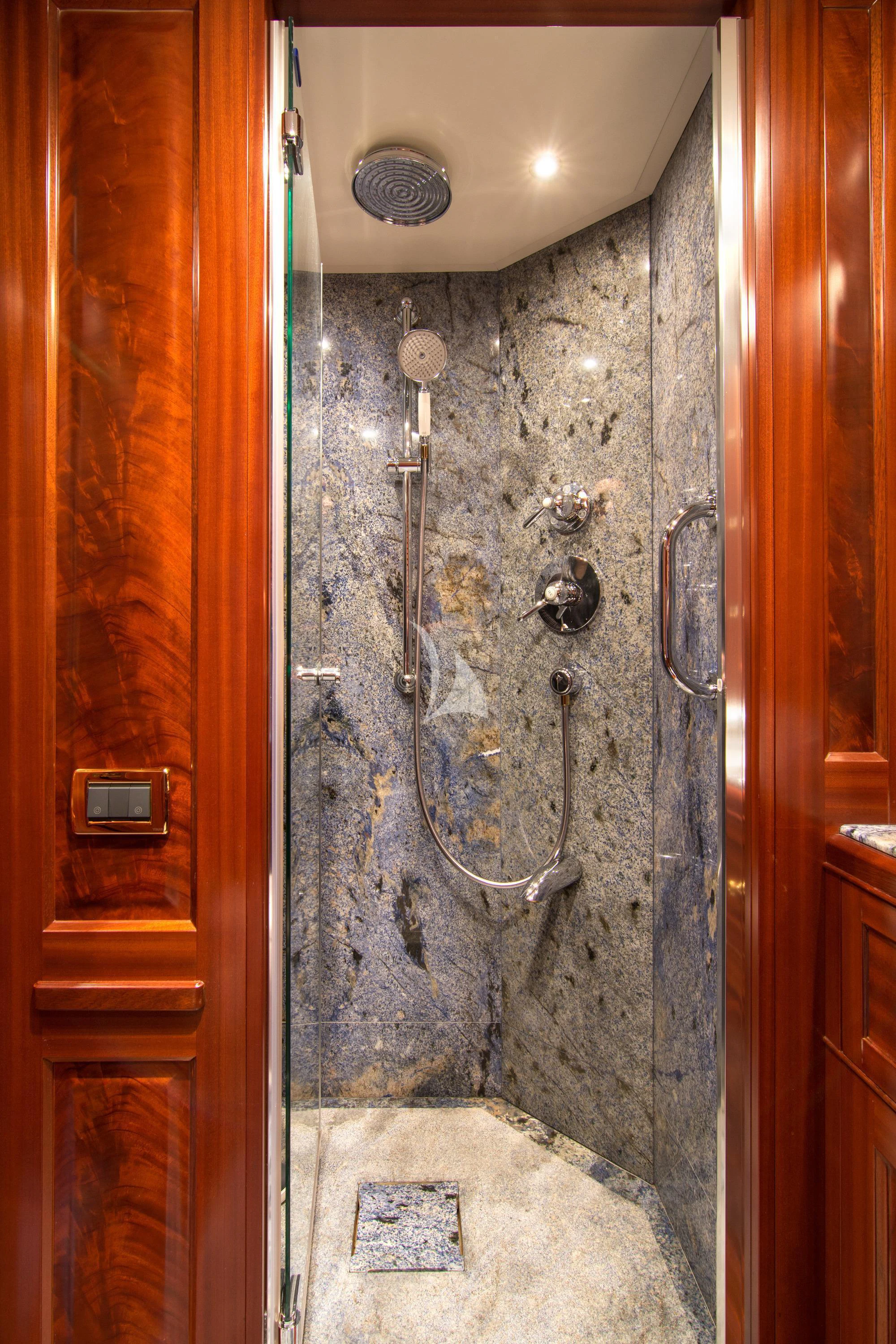 a shower with a tile wall aboard OPTION B Yacht for Charter