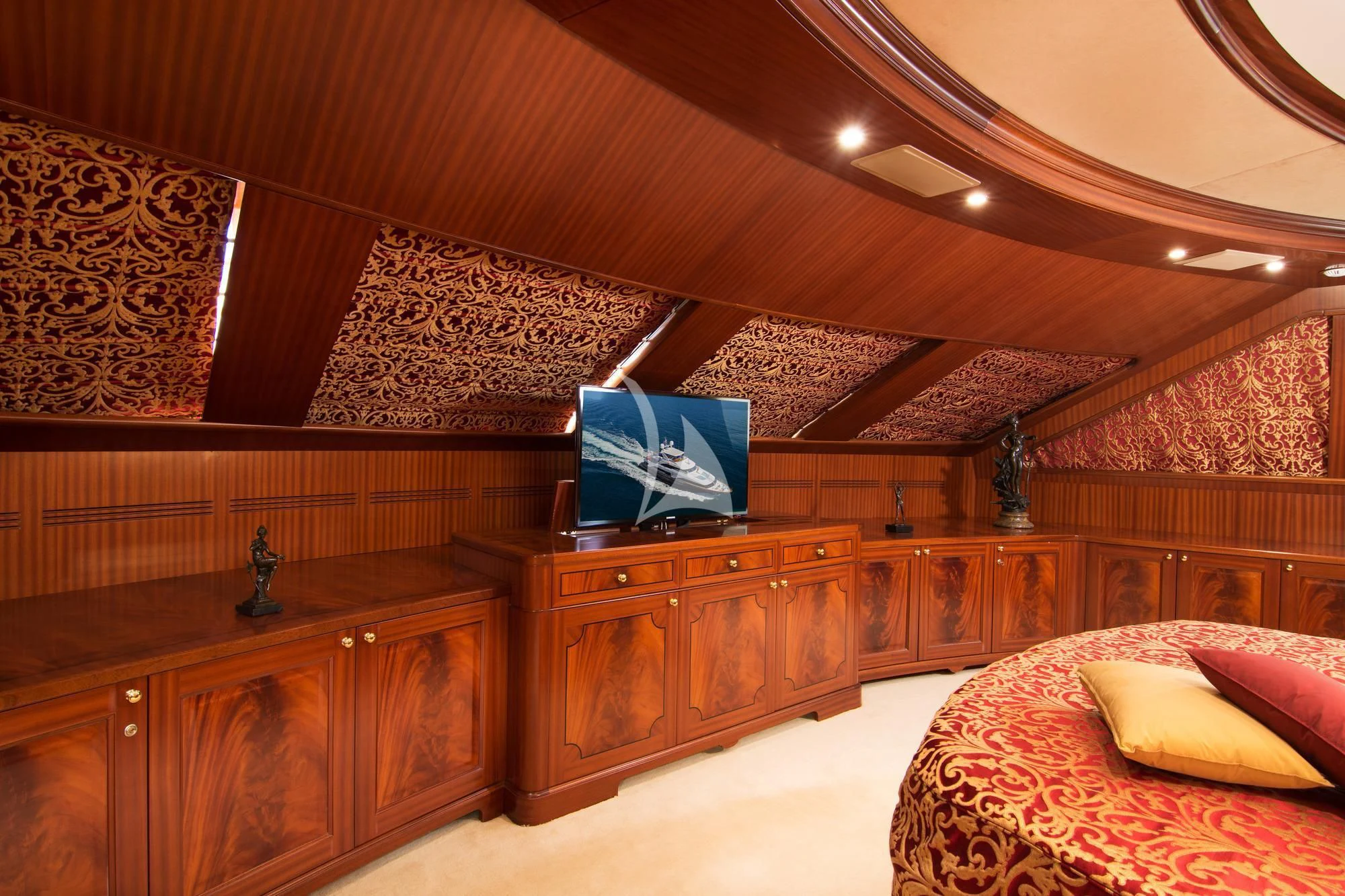 a room with a bed and a desk aboard OPTION B Yacht for Charter