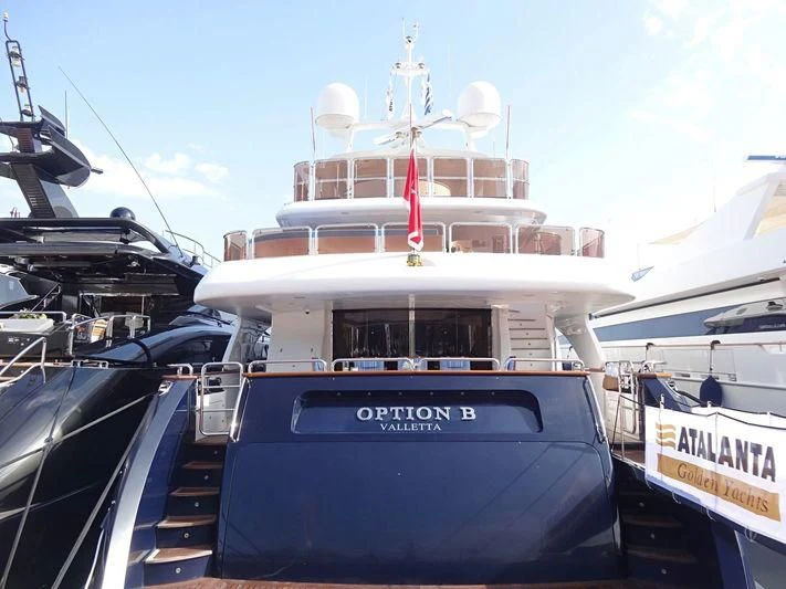 a large boat with a flag on the front aboard OPTION B Yacht for Charter