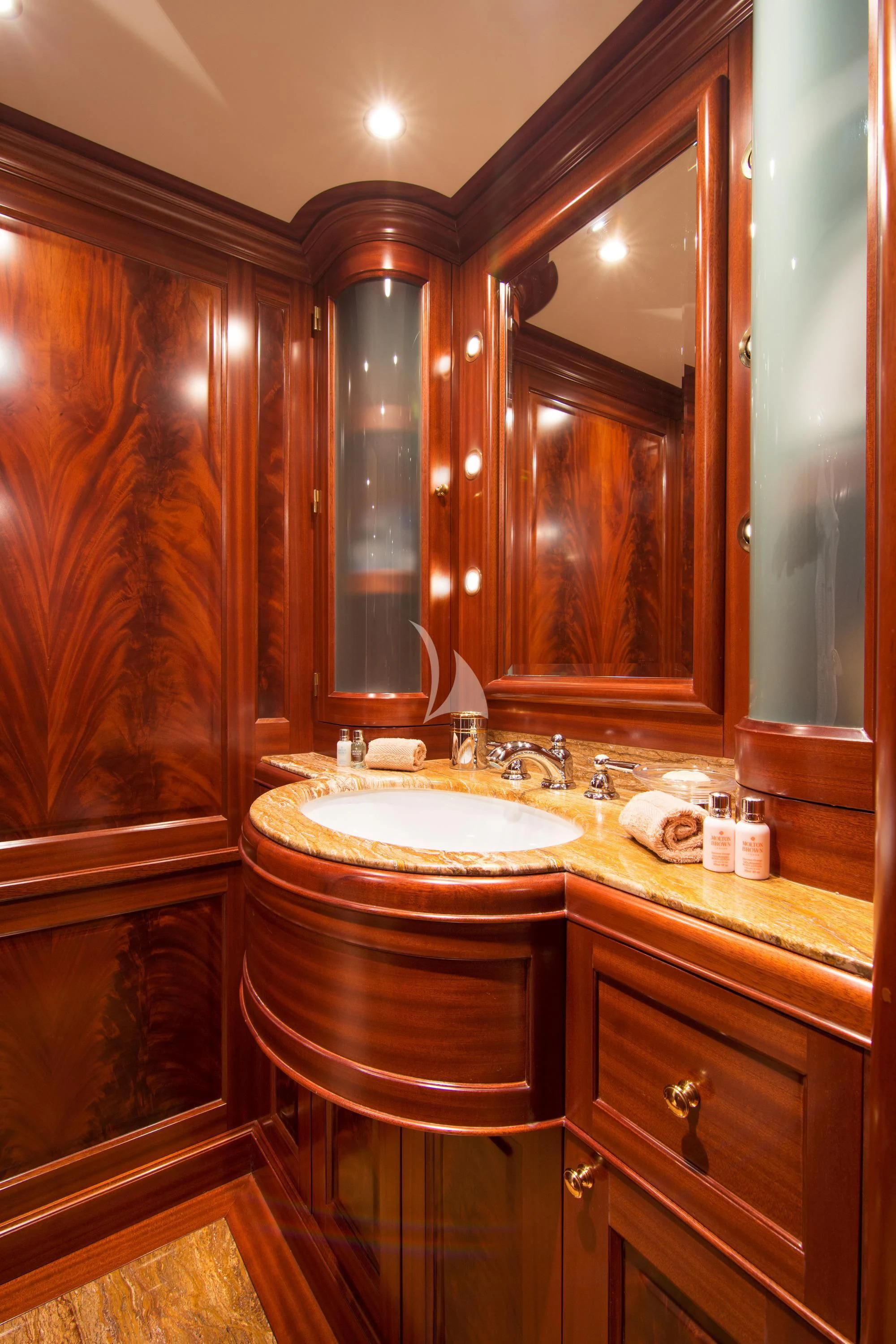 a bathroom with a sink and a mirror aboard OPTION B Yacht for Charter