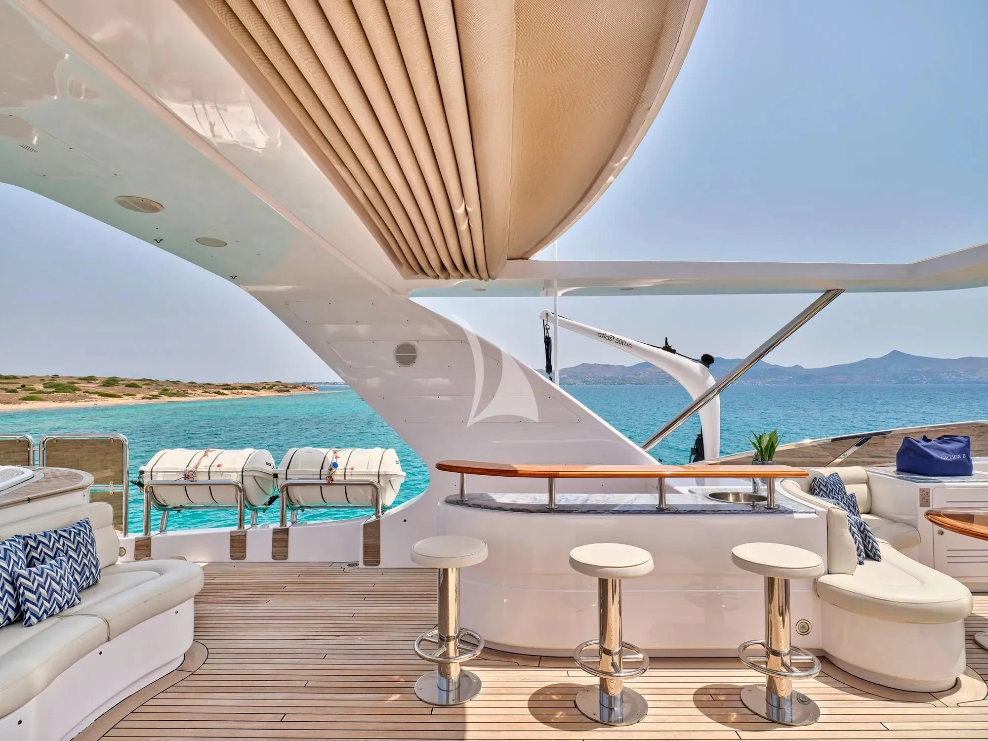 a lounge area with chairs and umbrellas aboard OPTION B Yacht for Charter