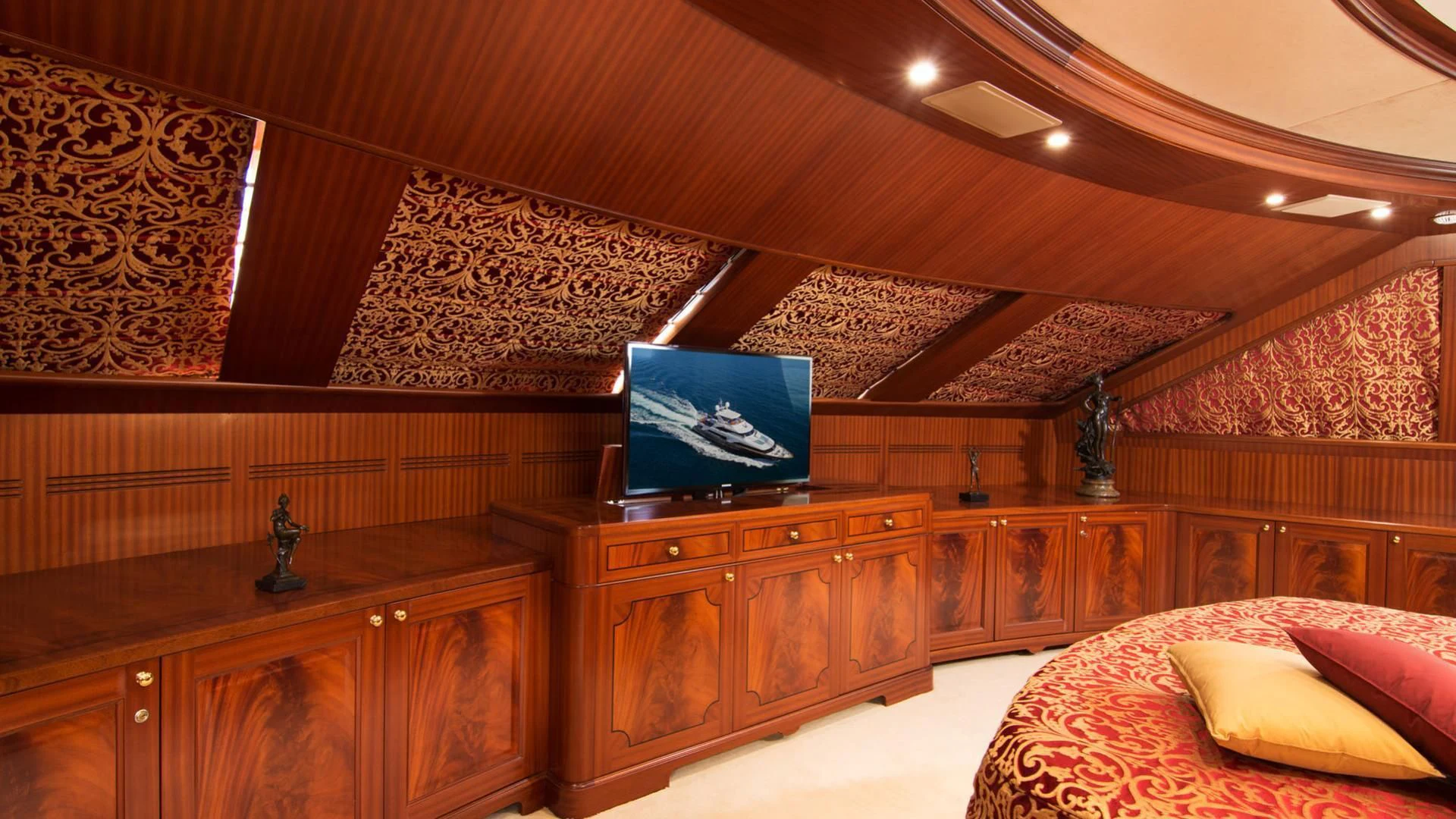 a room with a tv and a bed aboard OPTION B Yacht for Charter