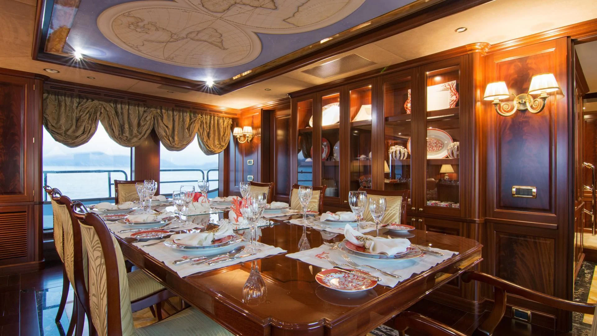 a dining room with a table set aboard OPTION B Yacht for Charter