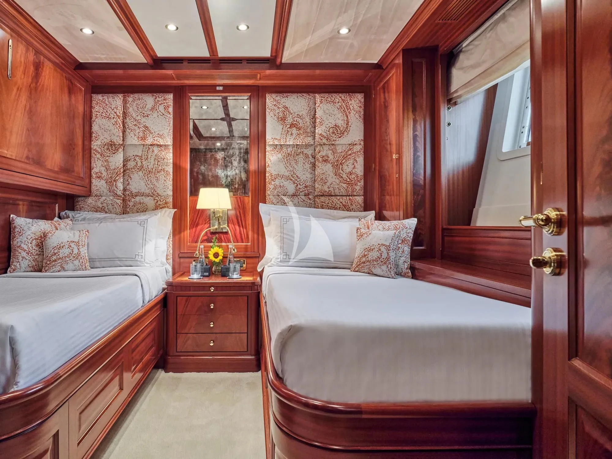 a bedroom with a bed and a mirror aboard OPTION B Yacht for Charter