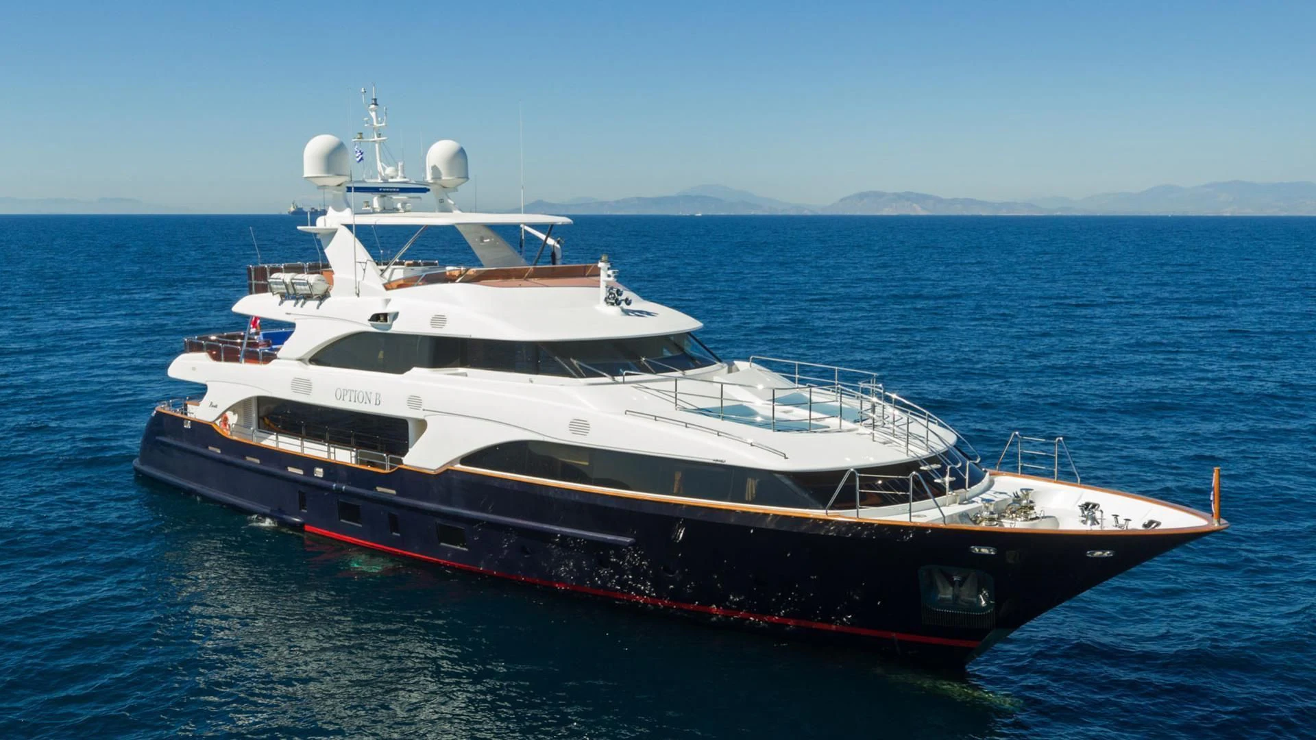 a large white boat in the water aboard OPTION B Yacht for Charter