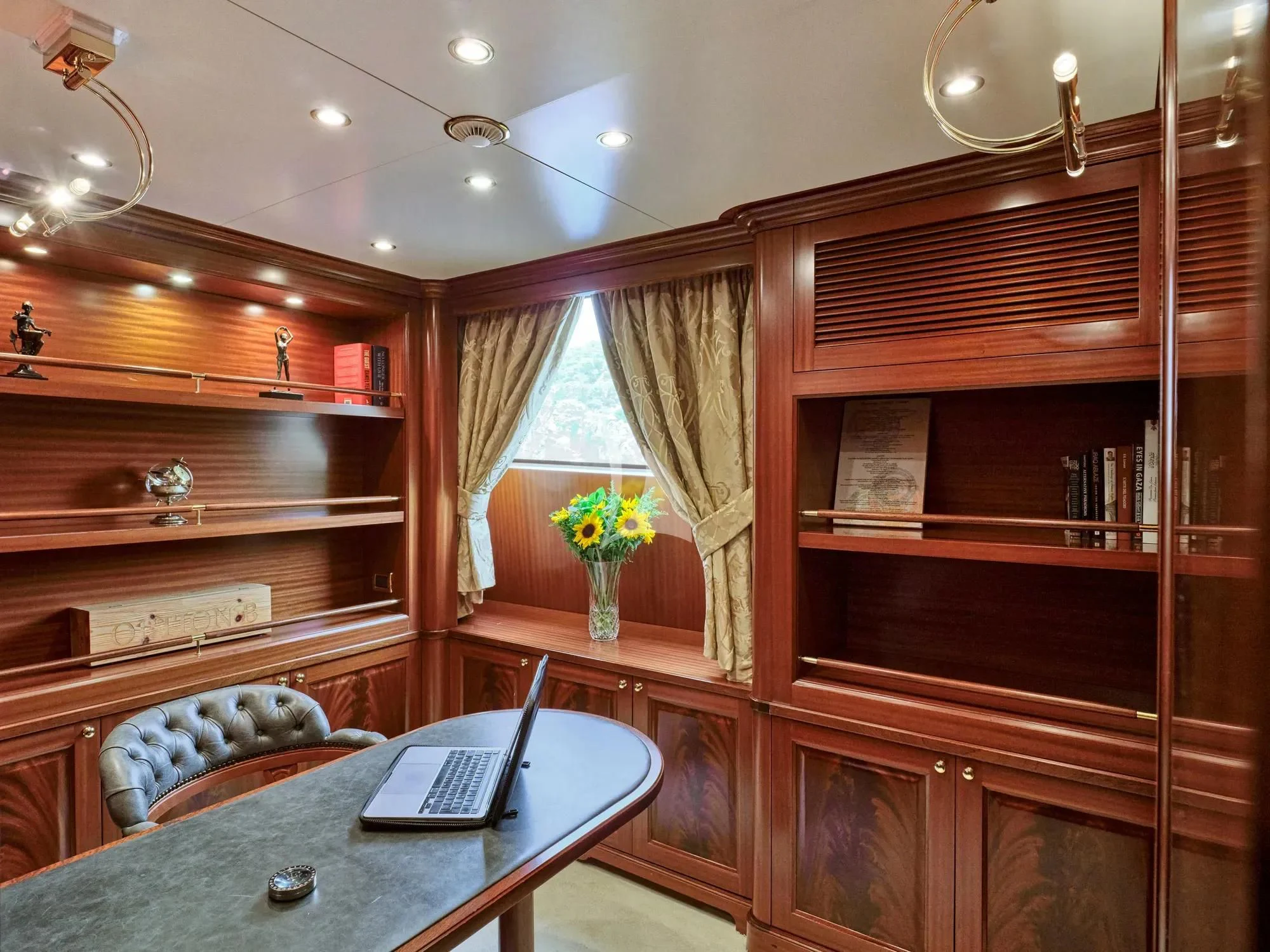 a room with a desk and a laptop aboard OPTION B Yacht for Charter