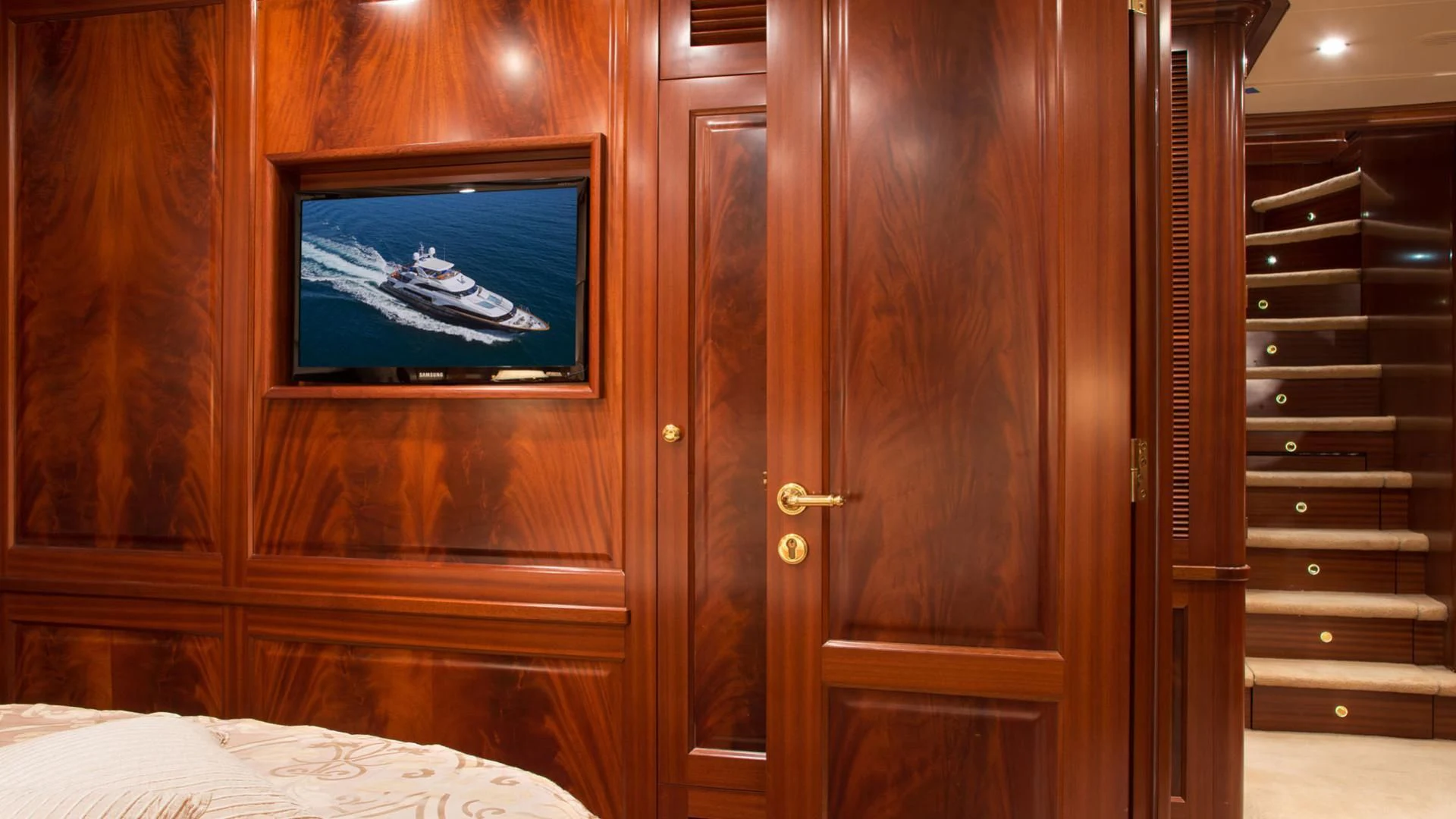 a room with a television and a bed aboard OPTION B Yacht for Charter