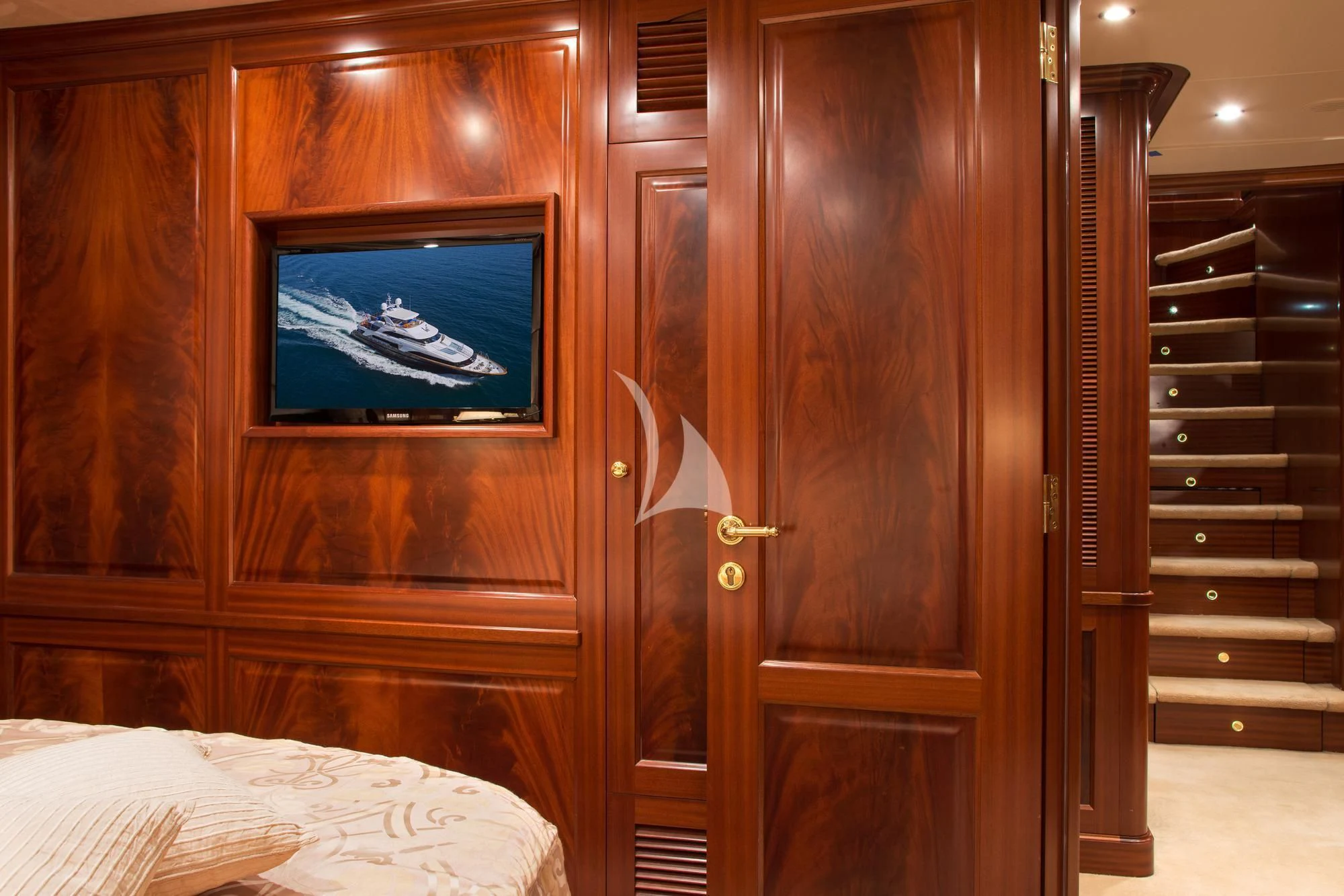 a room with a television and a bed aboard OPTION B Yacht for Charter
