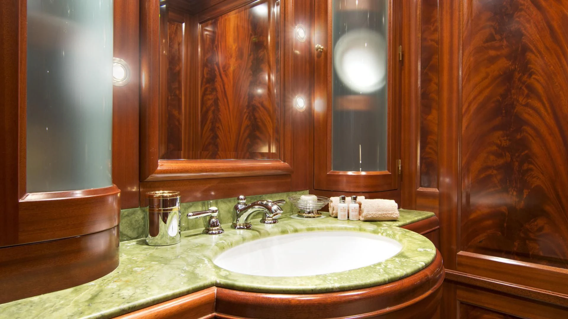a bathroom with a sink and a mirror aboard OPTION B Yacht for Charter