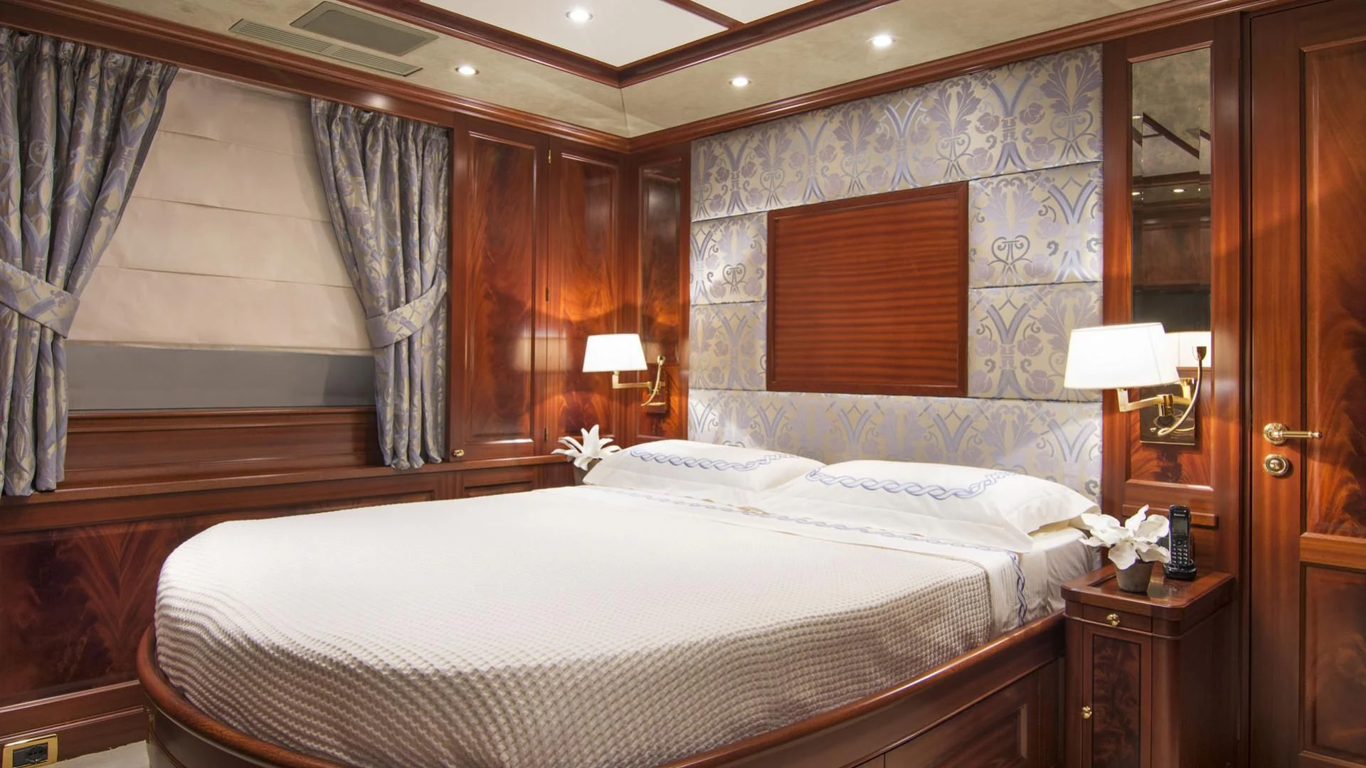 a bedroom with a large bed aboard OPTION B Yacht for Charter